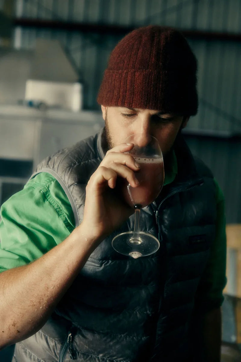 A person tasting wine in the cellar